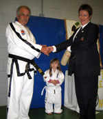 Master Howard presents Ms Keane with 6th Degree Black belt cert